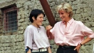 Diana, Princess of Wales, right, chats with Bosnian girl Mirzeta Gabelic, a 15 year-old landmine victim, in front of Mirzeta's home in Sarajevo, while Diana was on a visit to the region as part of her campaign against landmines on Aug. 10, 1997. (AP Photo /Hidajet Delic, File)