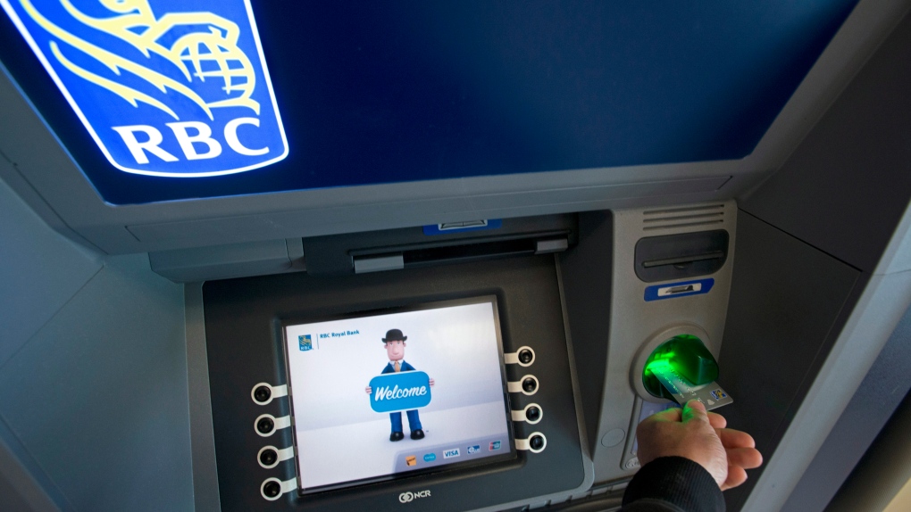 A Royal Bank client uses an RBC bank machine