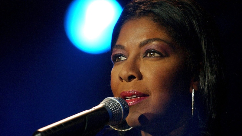 In a Sunday, July 6, 2003 file photo, singer Natalie Cole performs on Stravinsky stage, during the 37th Montreux Jazz Festival, in Montreux, Switzerland. (AP Photo/ Keystone, Martial Trezzini, File)