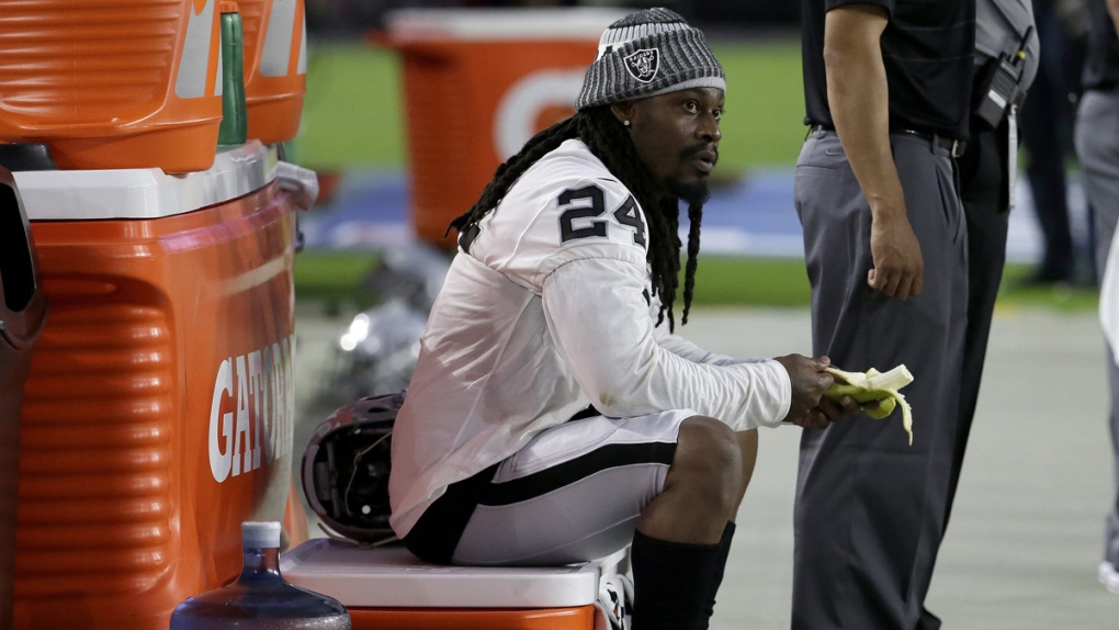 Marshawn Lynch sits during the national anthem