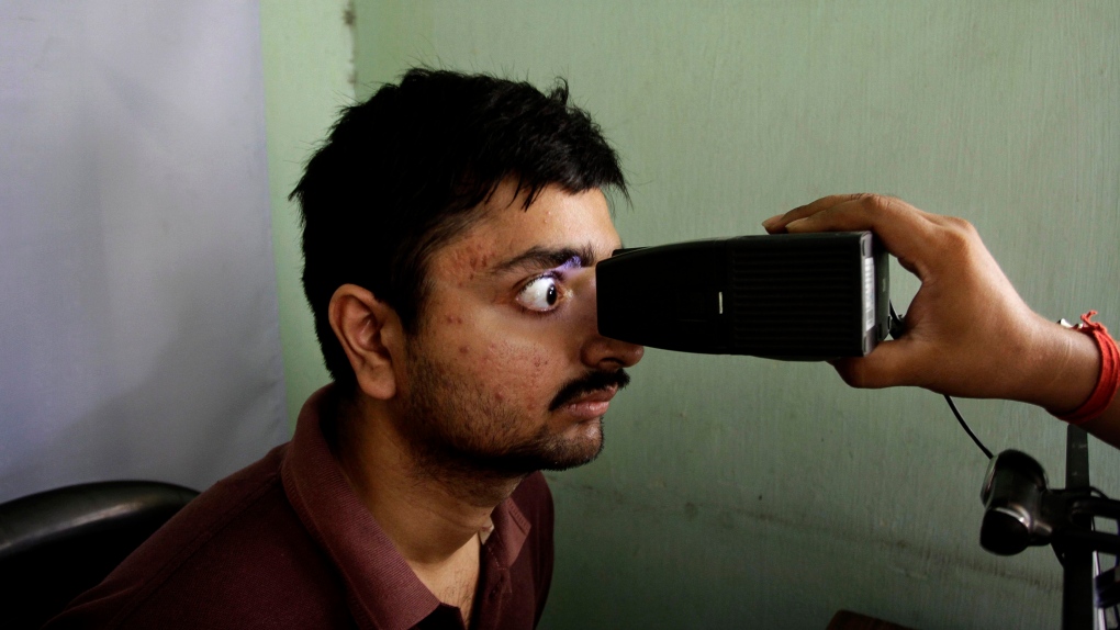 Indian man gets his retina scanned 
