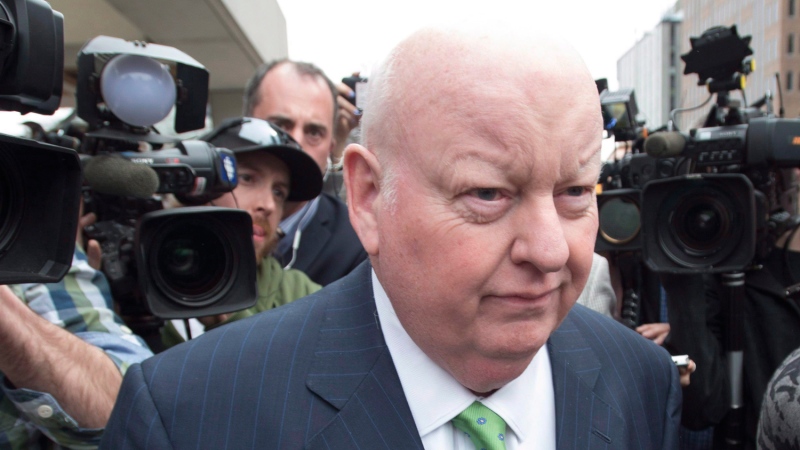 Sen. Mike Duffy walks past the cameras as he leaves the courthouse after being acquitted on all charges, Thursday, April 21, 2016 in Ottawa. THE CANADIAN PRESS/Adrian Wyld
