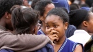 A student gestures as she stands with others, following a fire at the Moi Girls High School in Nairobi, Kenya Saturday, Sept. 2, 2017. (AP)