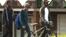 Jeremiah Perry's brothers and father walk his bike to the first day of school. 