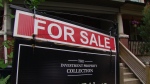 A real estate sign is pictured on a lawn. THE CANADIAN PRESS Jonathan Hayward