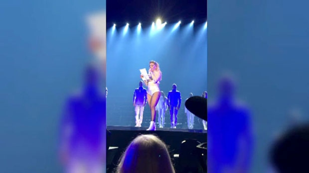 Lady Gaga reads out a letter from a fan, Dani Arnold, at her concert in Toronto on Sept. 7, 2017.