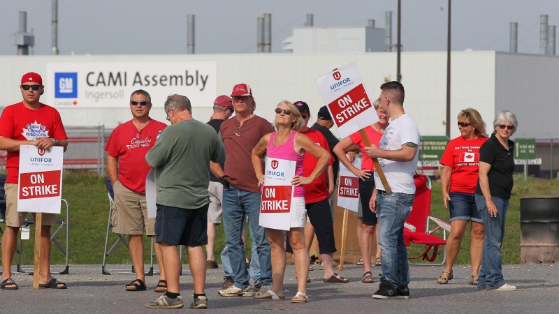 Employees of the GM CAMI assembly factory stand on the picket line in Ingersoll, Ont., on Sept. 18, 2017.  THE CANADIAN PRESS/Dave Chidley
