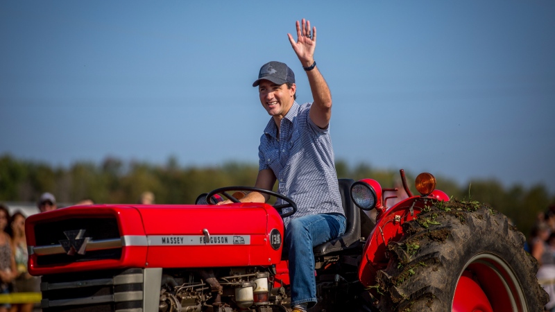 Justin Trudeau drives a tractor at the International Plowing Match and Rural Expo in Walton, Ont., on Friday, September 22, 2017. THE CANADIAN PRESS/Chris Donovan
