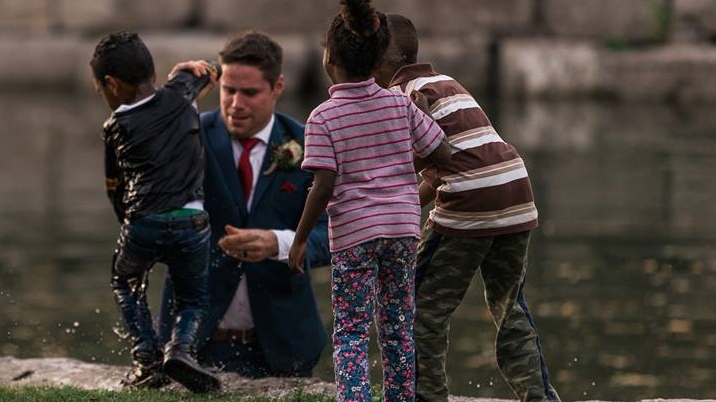 A groom pulls a young boy from the water in Victoria Park in Kitchener on Friday, Sept. 22, 2017
(Photo courtesy of Darren Hatt/Hatt Photograph)