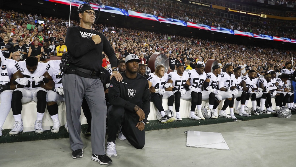 Oakland Raiders kneel during the anthem