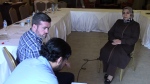 Bill Fortier (with a translator) interviews Ghazouah Almilagi, a journalist whose son was killed by a bomb in Syria.