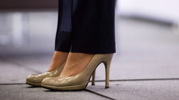 British Columbia Premier Christy Clark wears high heels while addressing the Council of Forest Industries convention in Vancouver, B.C., on Friday April 7, 2017. The British Columbia government has banned mandatory high heels in the workplace in a move to address "discriminatory" dress codes. Labour Minister Shirley Bond says requiring women to wear high heels on the job is also a health and safety issue. THE CANADIAN PRESS/Darryl Dyck