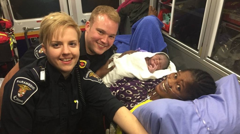 Ottawa Paramedics Courtney Healey and Matt Friesen pose with mom and newborn baby boy born in the ambulance while en route to hospital on Wednesday, Oct. 18, 2017. (Ottawa Paramedics)