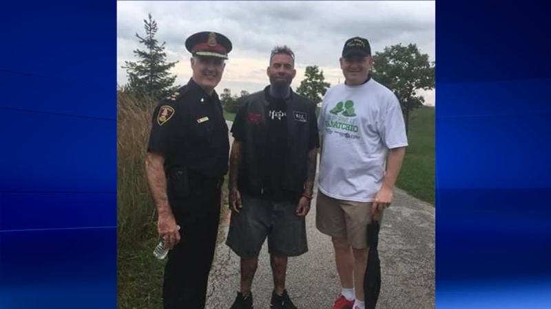 James Godden (centre) poses for a photo with Windsor Police Services Chief Al Fredrick (left) and Mayor Drew Dilkens at a walk for assault victim Anne Widholm in east-Windsor on October 15, 2017. (Photo courtesy of Facebook)