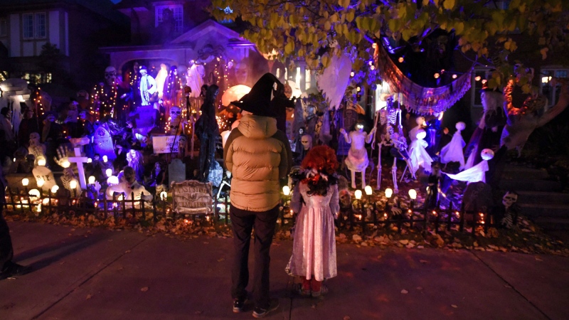Children trick-or-treat in Ottawa on Halloween, Monday, Oct. 31, 2016. The gleefully shouted phrase of "trick or treat" that children use when they call on houses at Halloween is getting a healthier response in cities across Canada.Instead of candy, little ghosts and goblins are getting passes to go swimming, skating and even skiing.THE CANADIAN PRESS/Justin Tang
