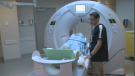 Technician helps a patient into the Montfort Hospital's brand new Cardiac CT Scanner. 