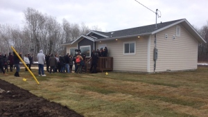 Community members gather outside a newly built home in Lake St. Martin First Nation on Thursday, Nov. 2, 2017. (Source: Twitter, Josh Crabb)