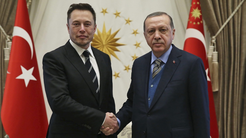 Erdogan, right, shakes hands with Musk