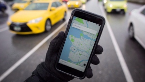 The Uber app is displayed on an iPhone as taxi drivers wait for passengers at Vancouver International Airport, in Richmond, B.C., on Tuesday, March 7, 2017. (THE CANADIAN PRESS / Darryl Dyck)