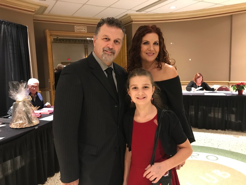 Dino Chiodo, the National Auto Director for Unifor, accepts a community service award with his family. (CTV Windsor / Angelo Aversa)