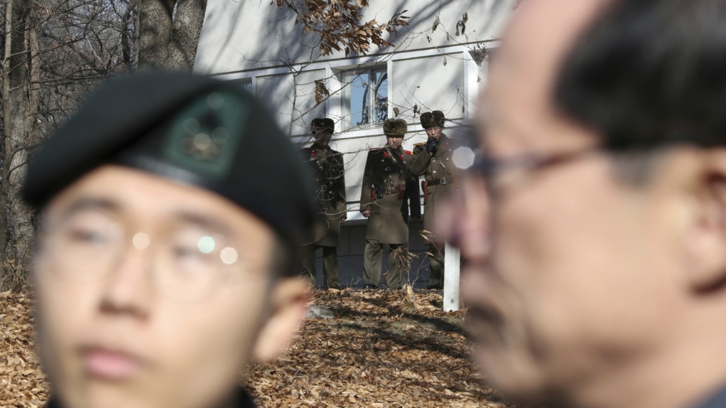 North Korean soldiers look at South Korean border