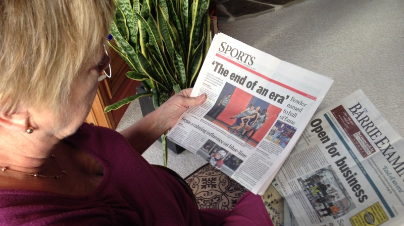 Donna Douglas, a former columnist for the Barrie Examiner, holds the last copy of the now shuttered newspaper on Monday, Nov. 27, 2017. (Mike Arsalides/ CTV Barrie)