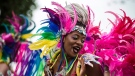 A parade participant performs during the Grand Parade at the Caribbean Carnival in Toronto on Saturday, Aug. 5, 2017. (THE CANADIAN PRESS/Christopher Katsarov)