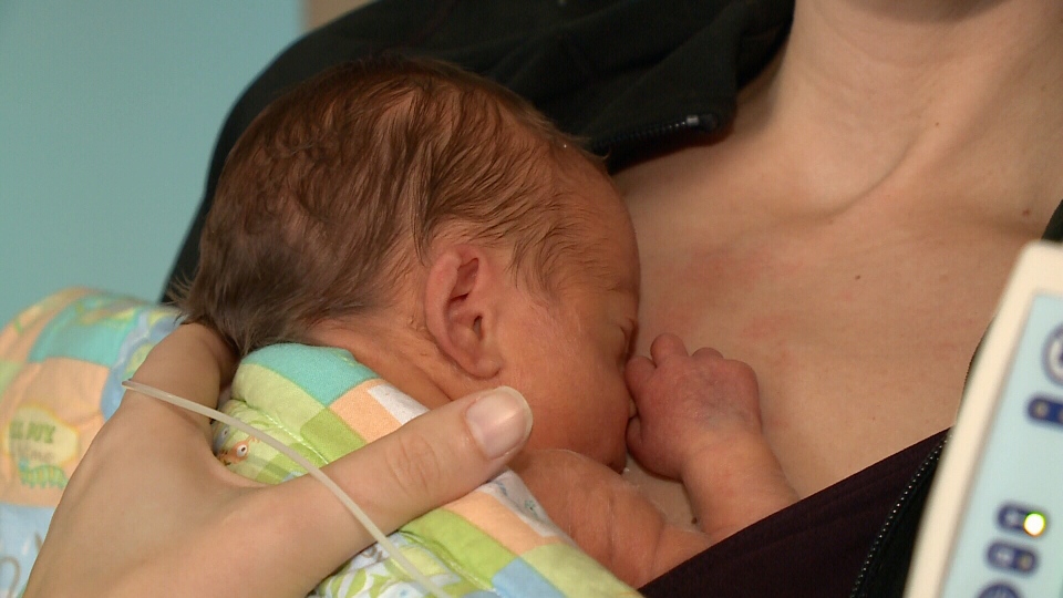 9-day-old baby Nash nestles against mom's chest 
