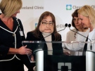 Connie Culp, second from left, who underwent the first face transplant surgery in the U.S., is helped to the podium by her head surgeon, Dr. Maria Siemionow, right, and other members of the transplant team at the Cleveland Clinic on Tuesday, May 5, 2009. (AP / Amy Sancetta)