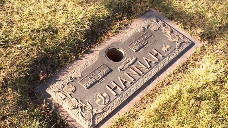 An empty hole is seen where a bronze vase once stood in the grave marker for Lucille Hannah's husband at Capital Memorial Gardens in Ottawa, Ont. 
