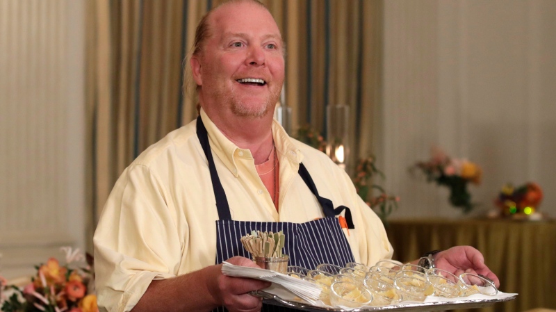 American chef Mario Batali holds a tray of pasta during a preview in advance of the State Dinner in honor of the Official Visit of Italian Prime Minister Matteo Renzi and his wife Agnese Landini in the State Dining Room of the White House in Washington, Monday, Oct. 17, 2016. (AP Photo/Carolyn Kaster)