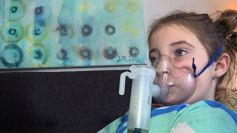 A machine pumps medicine into the lungs of nine-year-old Cassidy Evans, who has cystic fibrosis.
