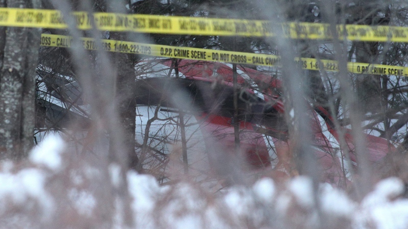 The crash Hydro One helicopter can be seen at the crash site near Tweed, Ont., on Dec. 14, 2017. (THE CANADIAN PRESS / Lars Hagberg)