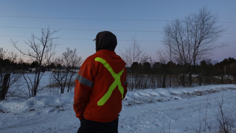 Hydro One works can be seen near the helicopter crash near Tweed, Ont., on Dec. 14, 2017. Four Hydro One employees were killed Thursday in a helicopter crash in eastern Ontario, police and the utility reported.The crash occurred about noon in Tweed, north of Kingston, provincial police said. THE CANADIAN PRESS/Lars Hagberg
