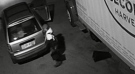 A man is seen handling a truck battery next to a Second Harvest truck in a surveillance camera image. (Second Harvest)