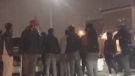Men with sticks are seen in a Brampton parking lot on Dec. 10 in a screen capture image. (Provided)