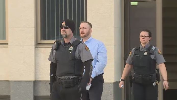 Aaron Murphy is escorted out of Court of Queen's Bench on Dec. 19, 2017 