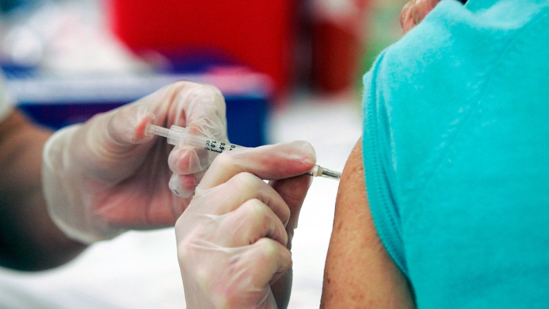 In this Sept. 1, 2009 file photo, Walgreen's pharmacy manager, Whitney Workman injects a customer with the seasonal flu vaccine in Columbia, S.C. (AP Photo/Mary Ann Chastain, File)