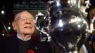 Canadian Second World War veteran and hockey hall of fame inductee Johnny Bower is seen next to the Memorial Cup as he takes part in a new exhibit dedicated to First World War and Second World War veterans at the Hockey Hall of Fame in Toronto on Monday, November 10, 2014. Following the Detroit Red Wings' tradition, the Toronto Maple Leafs now have empty stalls for franchise legends Bower, George Armstrong and Red Kelly in their locker-room at Air Canada Centre.(THE CANADIAN PRESS/Nathan Denette)