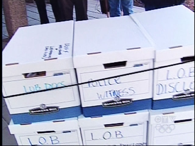The Crown prosecutor wheels boxes of evidence in the the case against Larry O'Brien into the Ontario Superior Court on Monday, May 11, 2009.