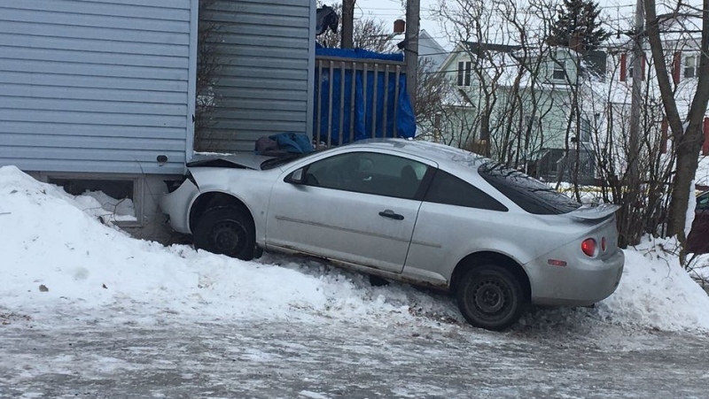 Cape Breton Regional Police say a car struck a woman before crashing into a home on St. Peter's Road in Sydney, N.S. on Jan. 11, 2018.