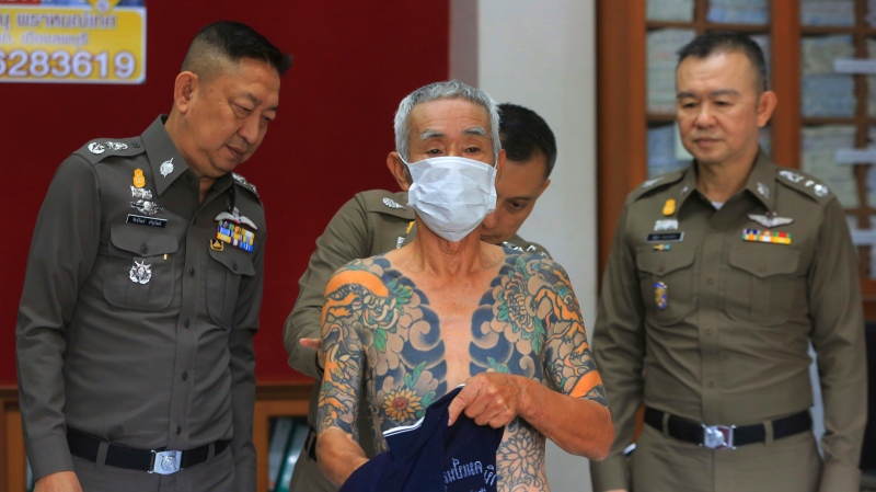 Japanese gang member Shigeharu Shirai displays his tattoos at a police station during a press conference in Lopburi, central Thailand, Thursday, Jan. 11, 2018. (AP Photo)