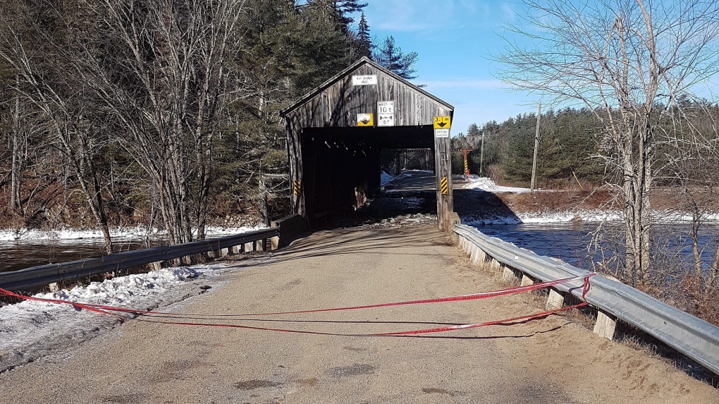 covered bridge damaged in storm