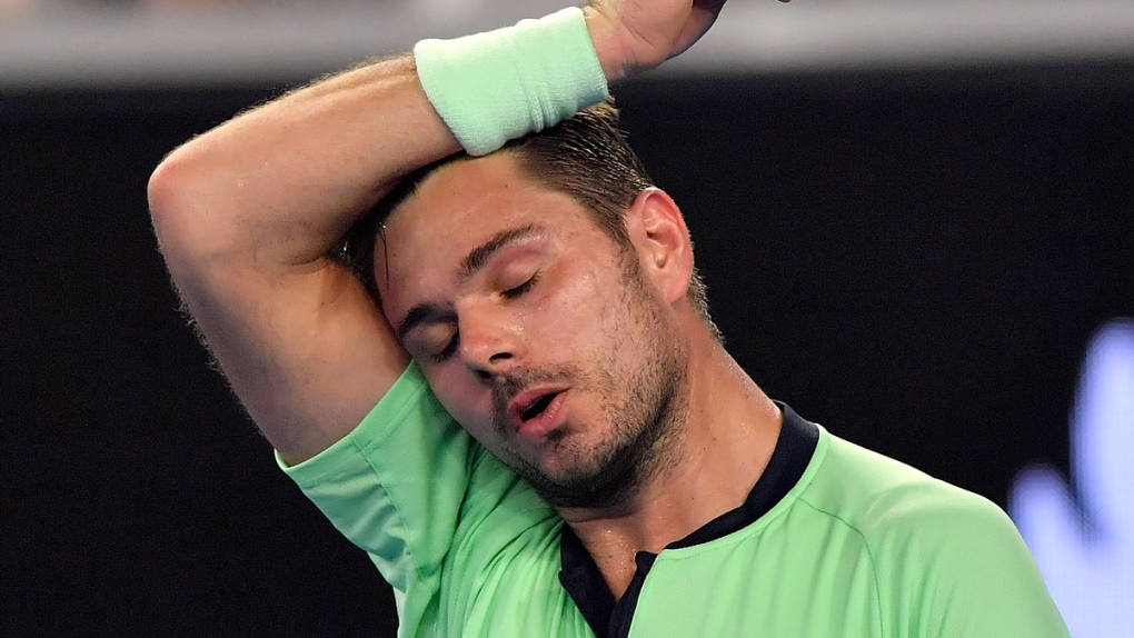 Stan Wawrinka wipes the sweat from his face