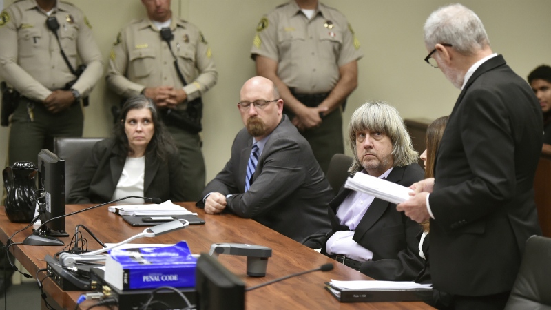 Louise Anna Turpin, far left, with attorney Jeff Moore, second from left, and her husband David Allen Turpin, listen to attorney, David Macher, as they appear in court for their arraignment in Riverside, Calif., Thursday, Jan. 18, 2018. (Frederic J. Brown/Pool Photo via AP)