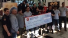 Members of Windsor Fire and Rescue Services present a cheque for $15,000\ to the Fight Like Mason Foundation on Jan. 19, 2018. (Michelle Maluske / CTV Windsor)