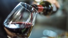 Red wine is poured into a glass in this file photo. (Instants / Istock.com)