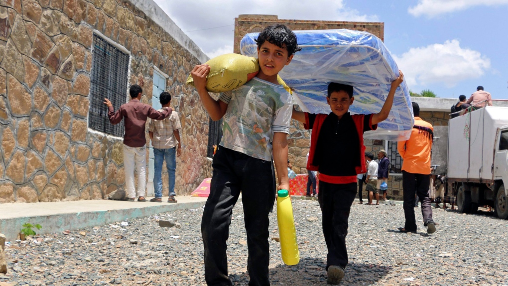 Boys carrying supplies in Aden, Taiz, Yemen