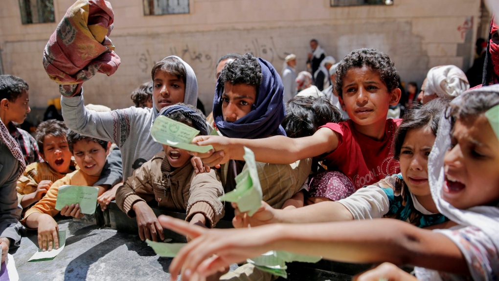 Yemenis present documents in order to receive food