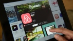 Airbnb says it will spend the next year verifying that all 7 million of its listings are accurate and that the homes and rooms being offered for short-term stays meet basic quality standards. (AFP PHOTO/John MACDOUGALL)